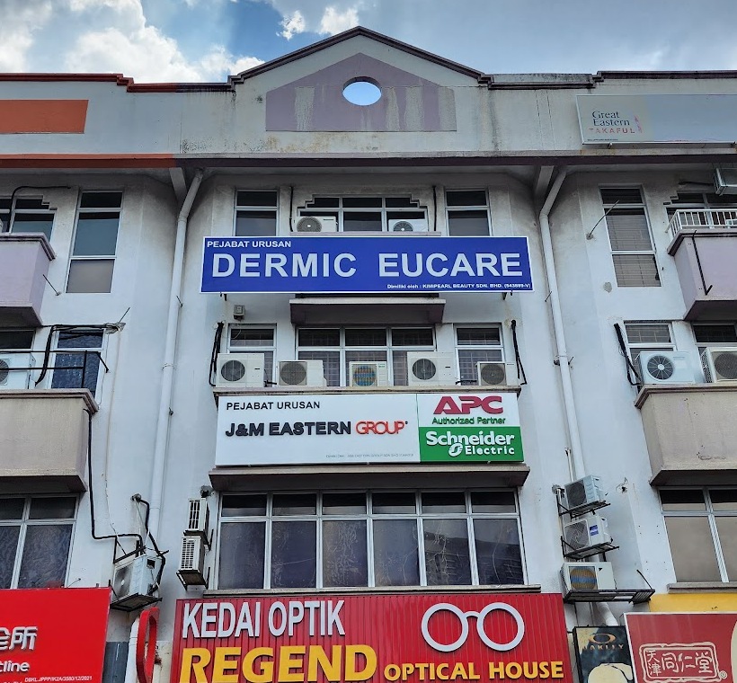 Shophouse facade with a first-floor signboard reading Pejabat Urusan J&M Eastern Group beside APC Authorized Partner and Schneider Electric logos