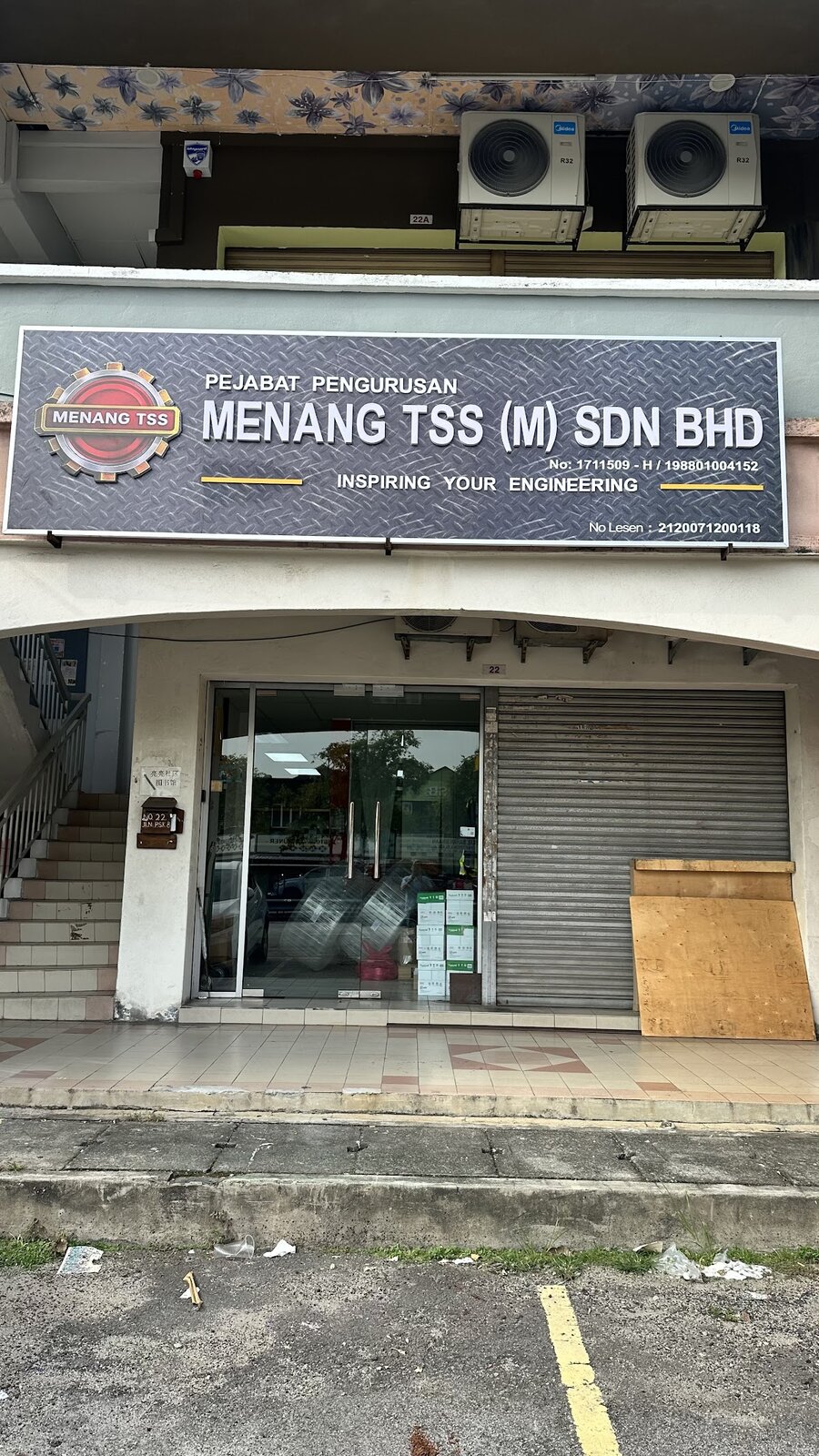 Shop-lot office with a dark Menang TSS (M) Sdn Bhd Pejabat Pengurusan signboard above a glass door and shutter