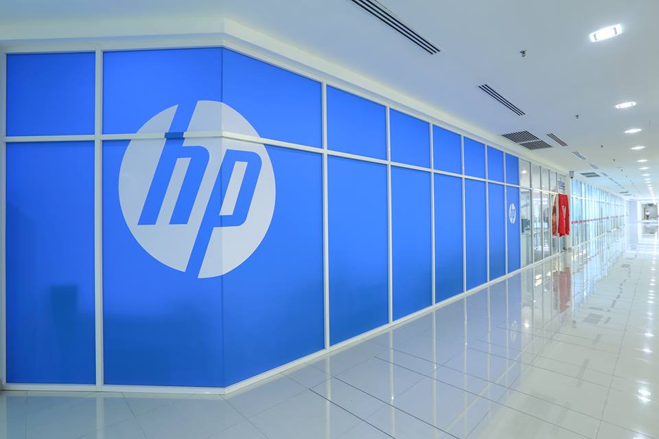 Corridor wall of blue glass panels with a large HP logo