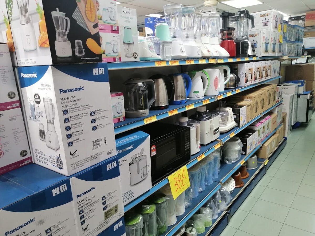 Shop aisle with shelves of boxed blenders, kettles and kitchen appliances, many Panasonic