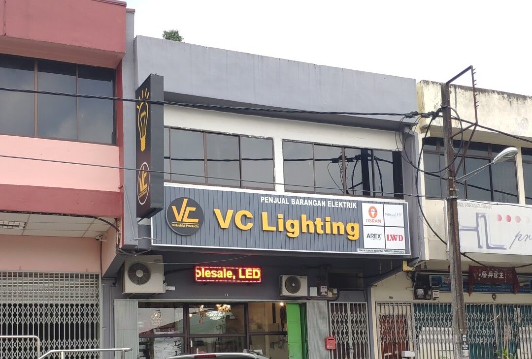 Two-storey shophouse row with a grey "VC Lighting" signboard and an LED ticker above the shop