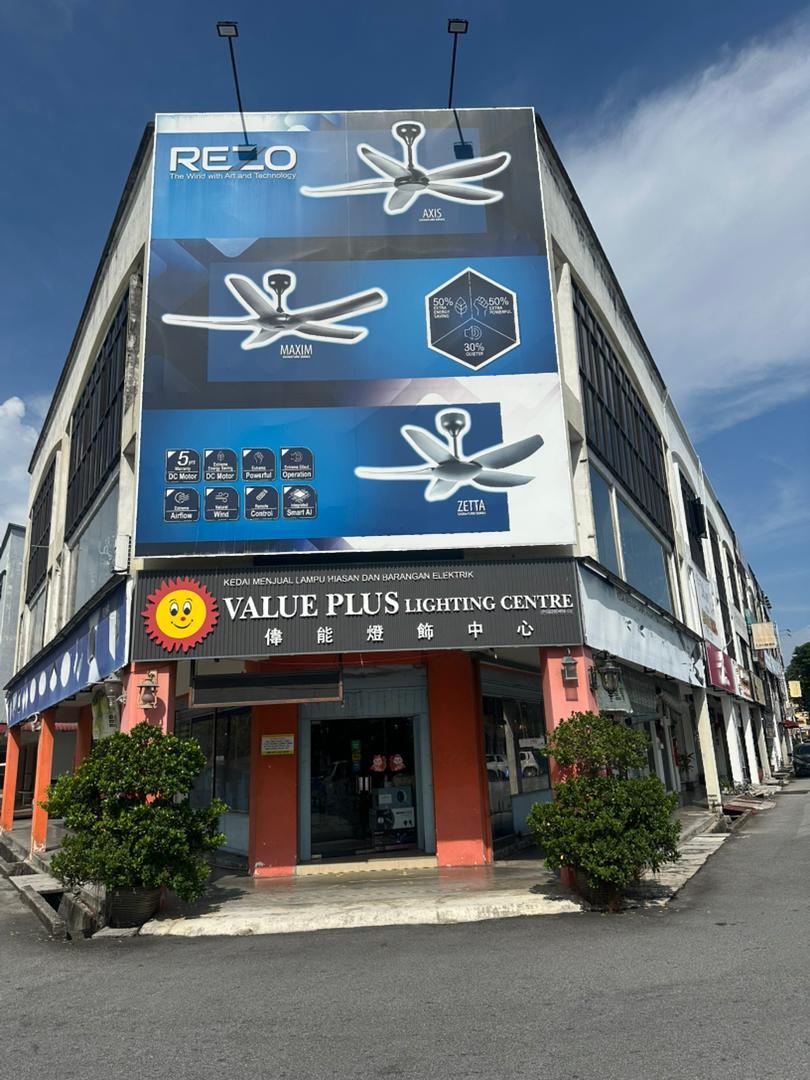 Corner shophouse with a large blue Rezo fan billboard over a black Value Plus Lighting Centre signboard