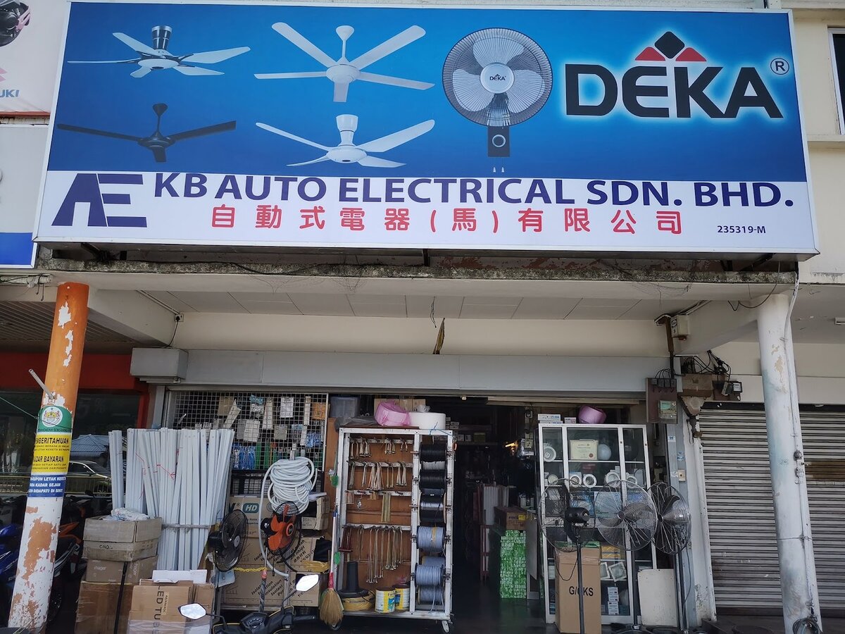 Shopfront under a blue signboard with ceiling fans and the KB Auto Electrical name, with fans and stock racks inside the open entrance
