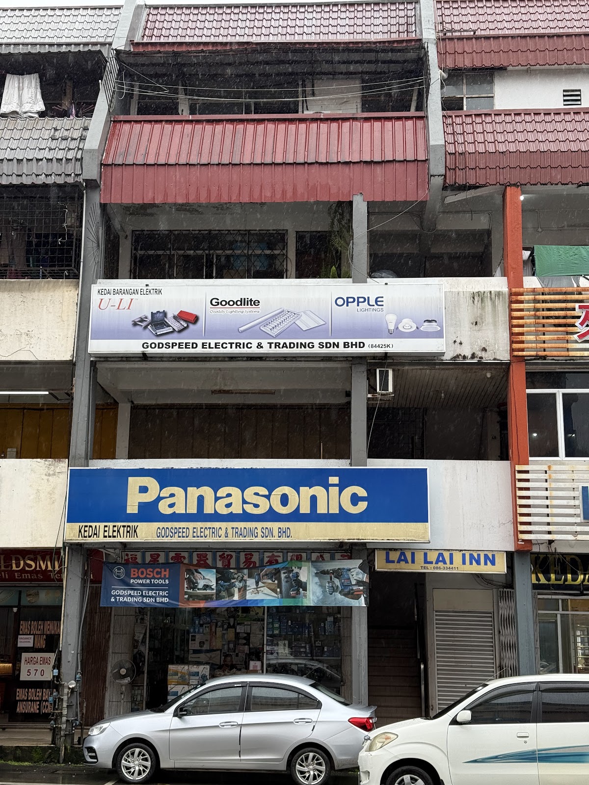 Shophouse with a light-blue U-LI, Goodlite and Opple signboard above a blue Panasonic Kedai Elektrik signboard