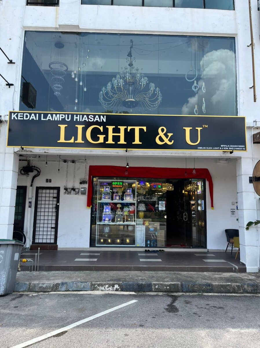 Shophouse with a black "Kedai Lampu Hiasan Light & U" signboard and a chandelier in the upper-floor window