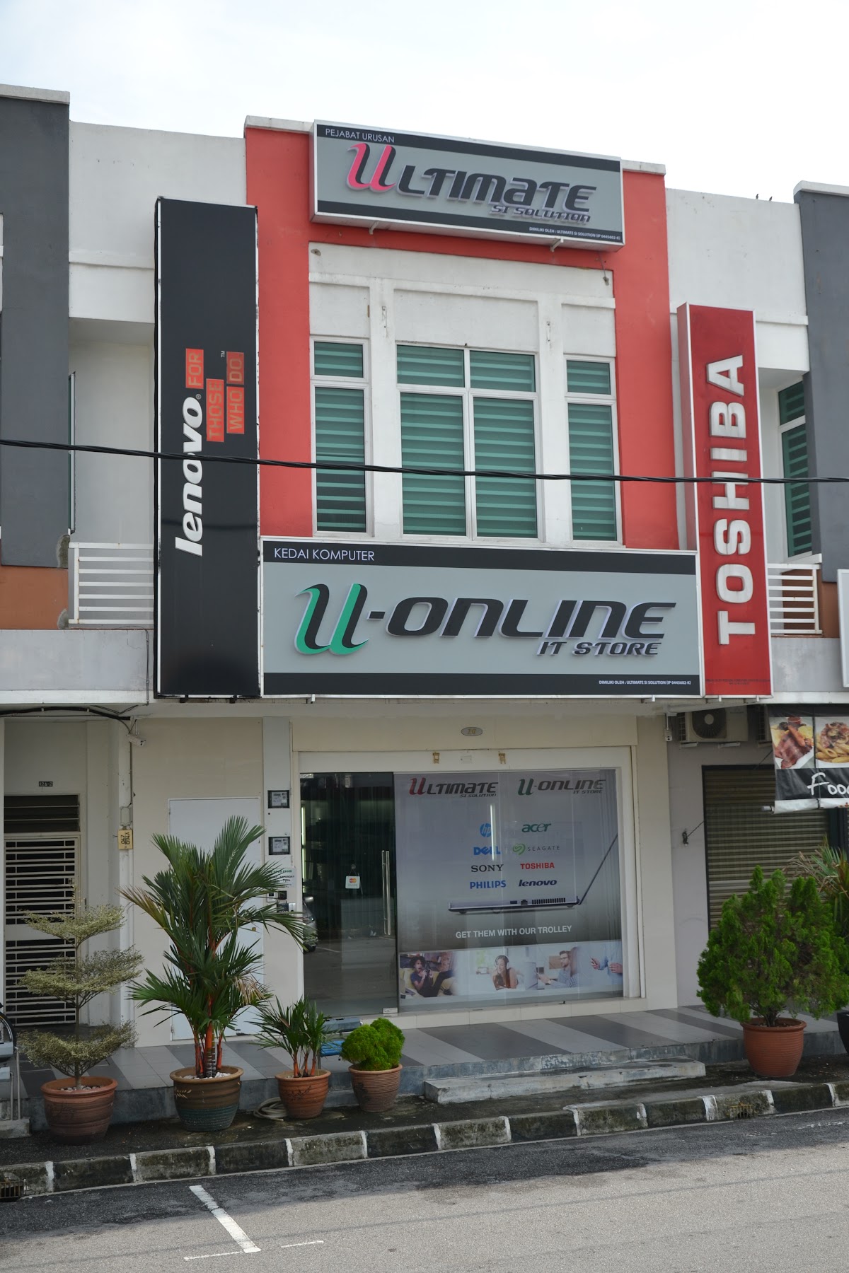 Two-storey shop lot with Ultimate and U-Online IT Store signboards and Lenovo and Toshiba side signs