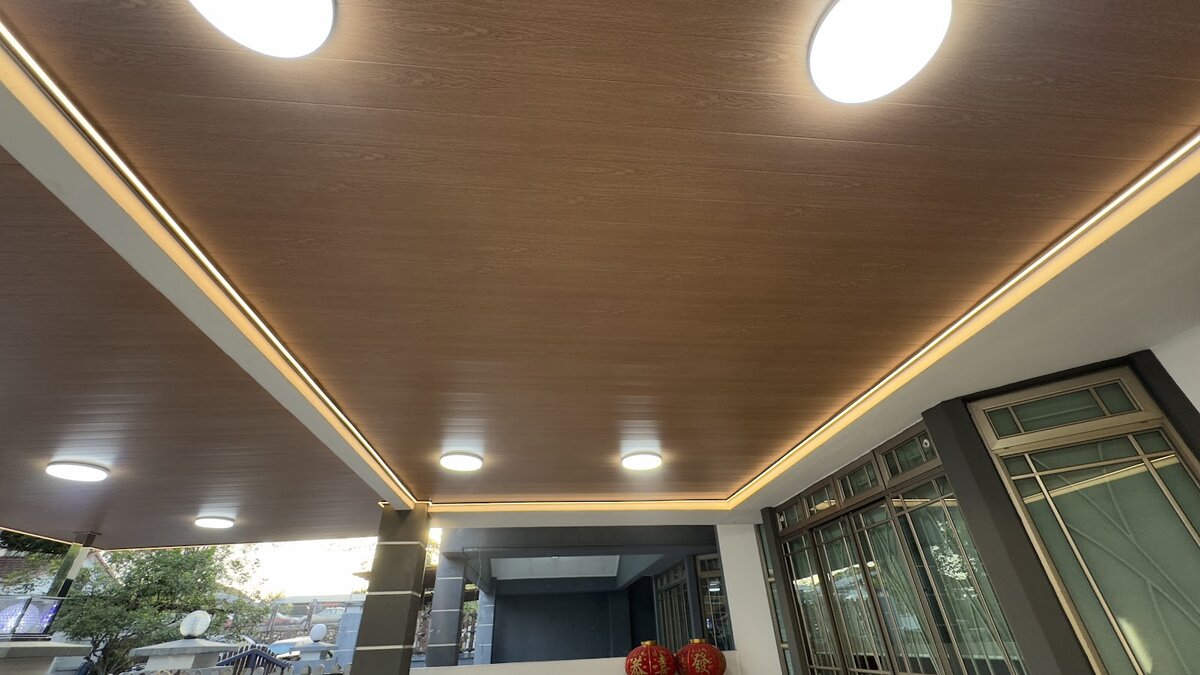 Wood-panel porch ceiling with round ceiling lights and a warm LED strip around the edge