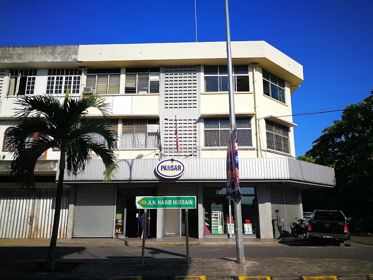Three-storey cream corner shophouse with an oval PANSAR sign and a Jalan Habib Hussain street sign in front