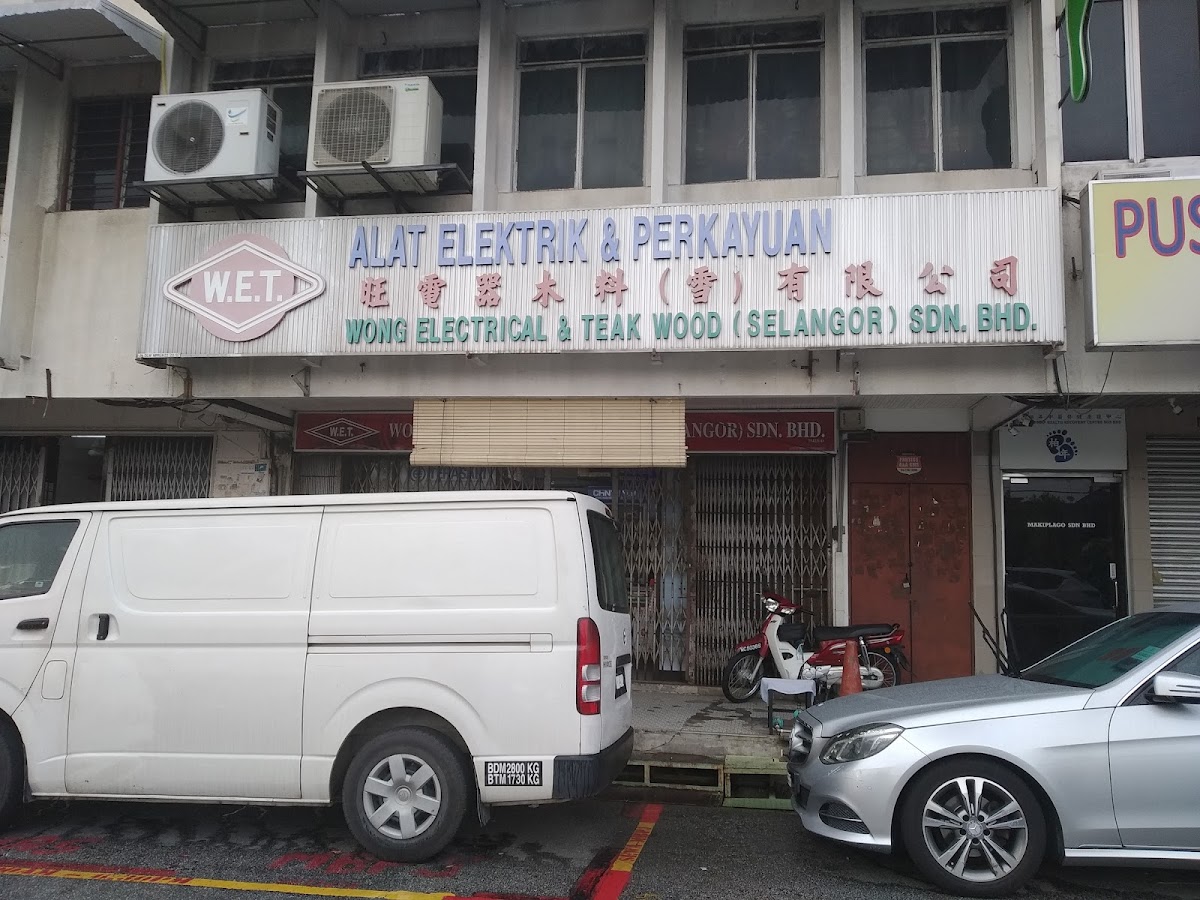 Shophouse with a W.E.T. Wong Electrical & Teak Wood (Selangor) Sdn Bhd signboard, a white van parked in front