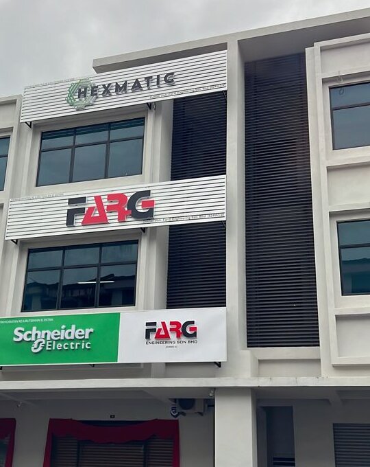 Three-storey white shoplot with a Hexmatic sign on the top floor, a FARG sign on the first floor and a green Schneider Electric and FARG signboard over the ground floor
