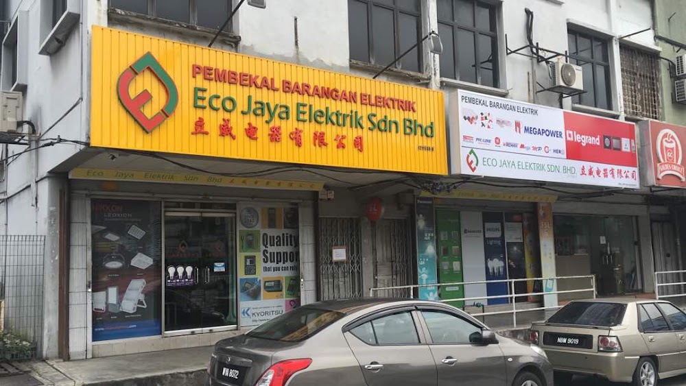 Shopfront with a yellow Eco Jaya Elektrik Sdn Bhd signboard and a white panel with Megapower and Legrand logos