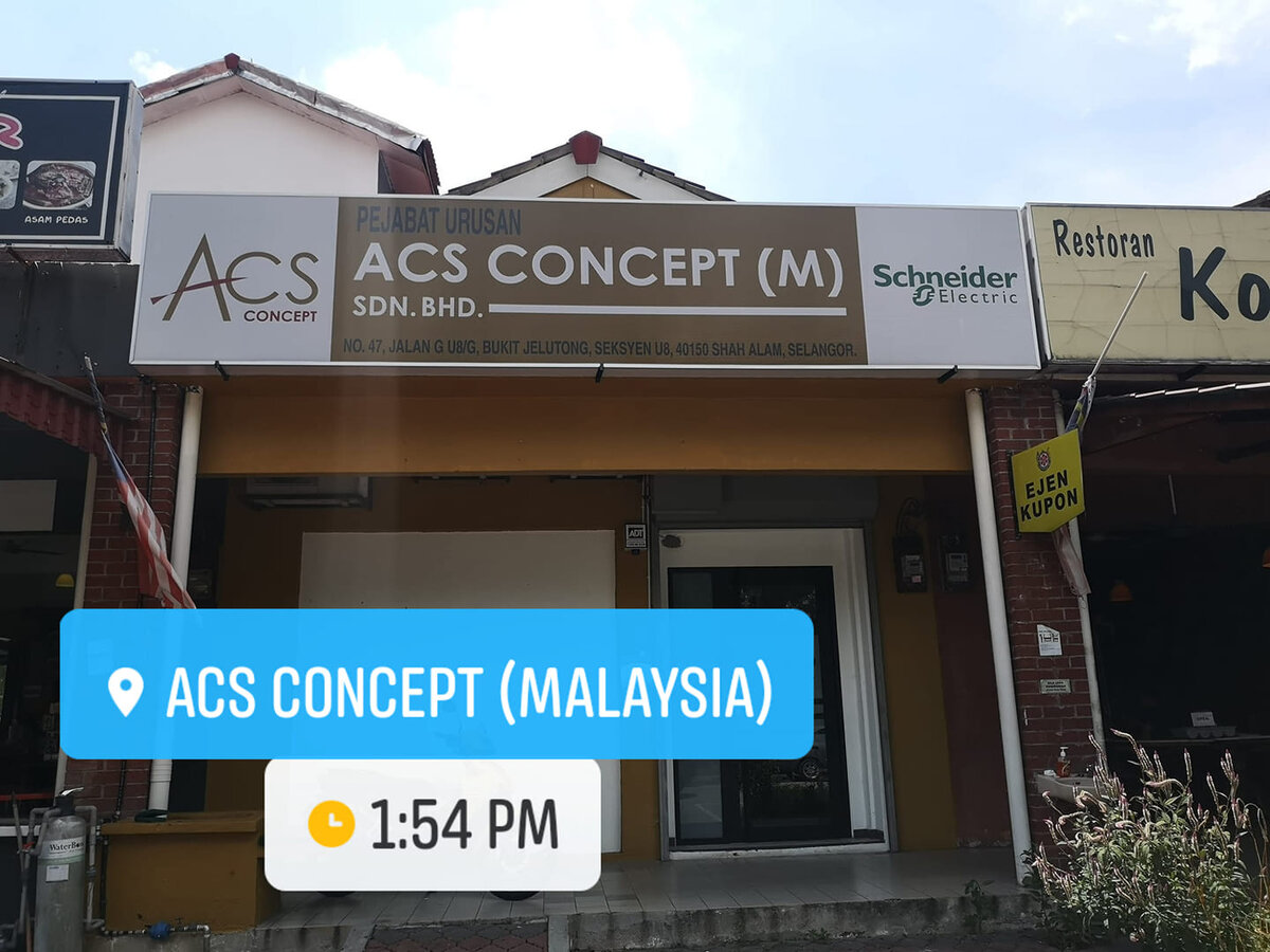 Single-storey shoplot with a beige ACS Concept (M) Sdn Bhd signboard, the ACS logo on the left and the Schneider Electric logo on the right