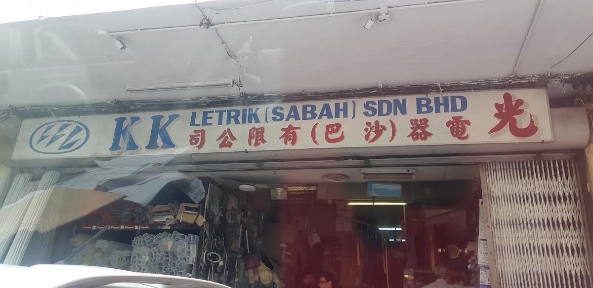 Shophouse frontage with a K K Letrik (Sabah) Sdn Bhd signboard in English and Chinese above an open shop