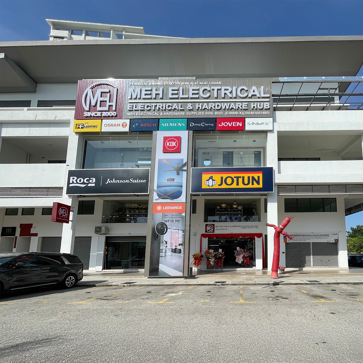 Shoplot with a large MEH Electrical & Hardware Hub signboard, a row of brand logos and Roca, KDK and Jotun signs above the entrance