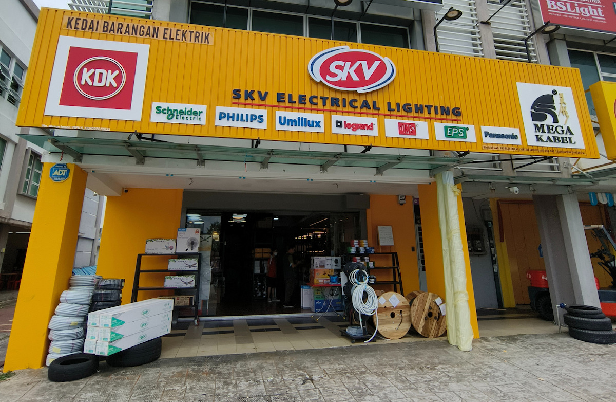Yellow shopfront signed SKV Electrical Lighting with KDK, Schneider Electric, Philips, Umilux, Legrand, EPS, Panasonic and Mega Kabel panels, with cable coils and drums outside