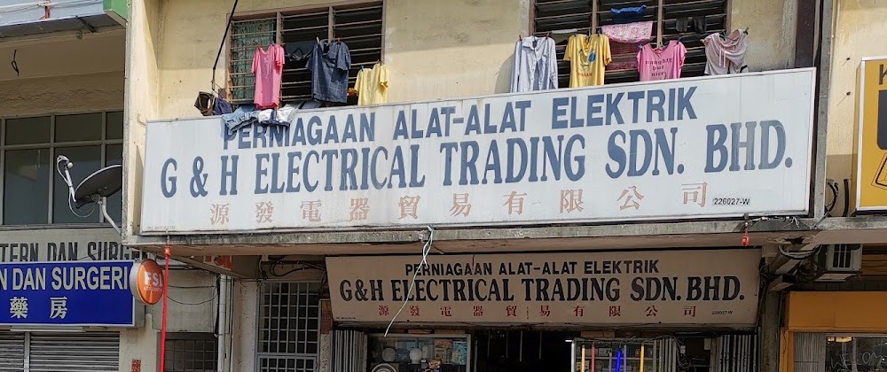 Two shop signboards reading Perniagaan Alat-Alat Elektrik, G&H Electrical Trading Sdn. Bhd., with Chinese characters below
