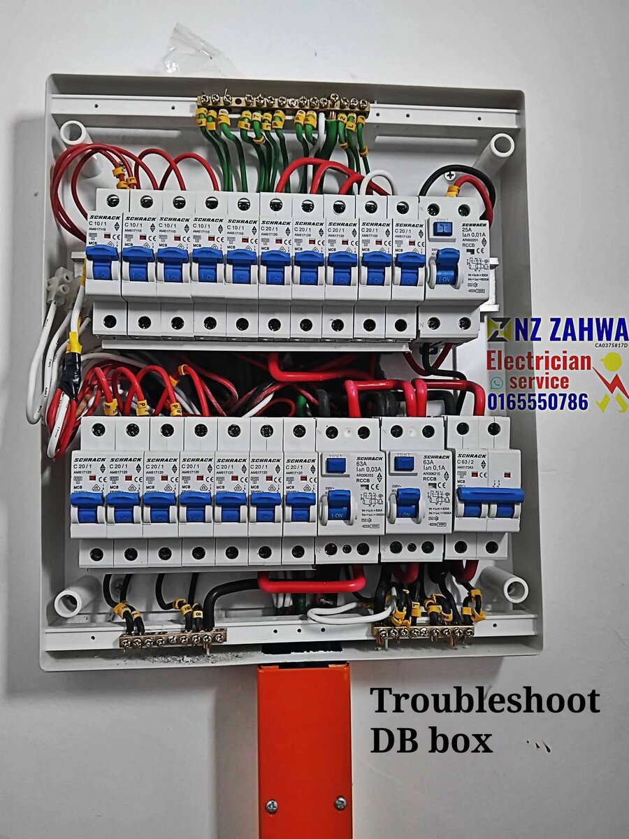 Open distribution board with two rows of white Schrack miniature circuit breakers with blue toggles, red and black wires and an earth bar, with an NZ Zahwa Electrician service watermark and phone number