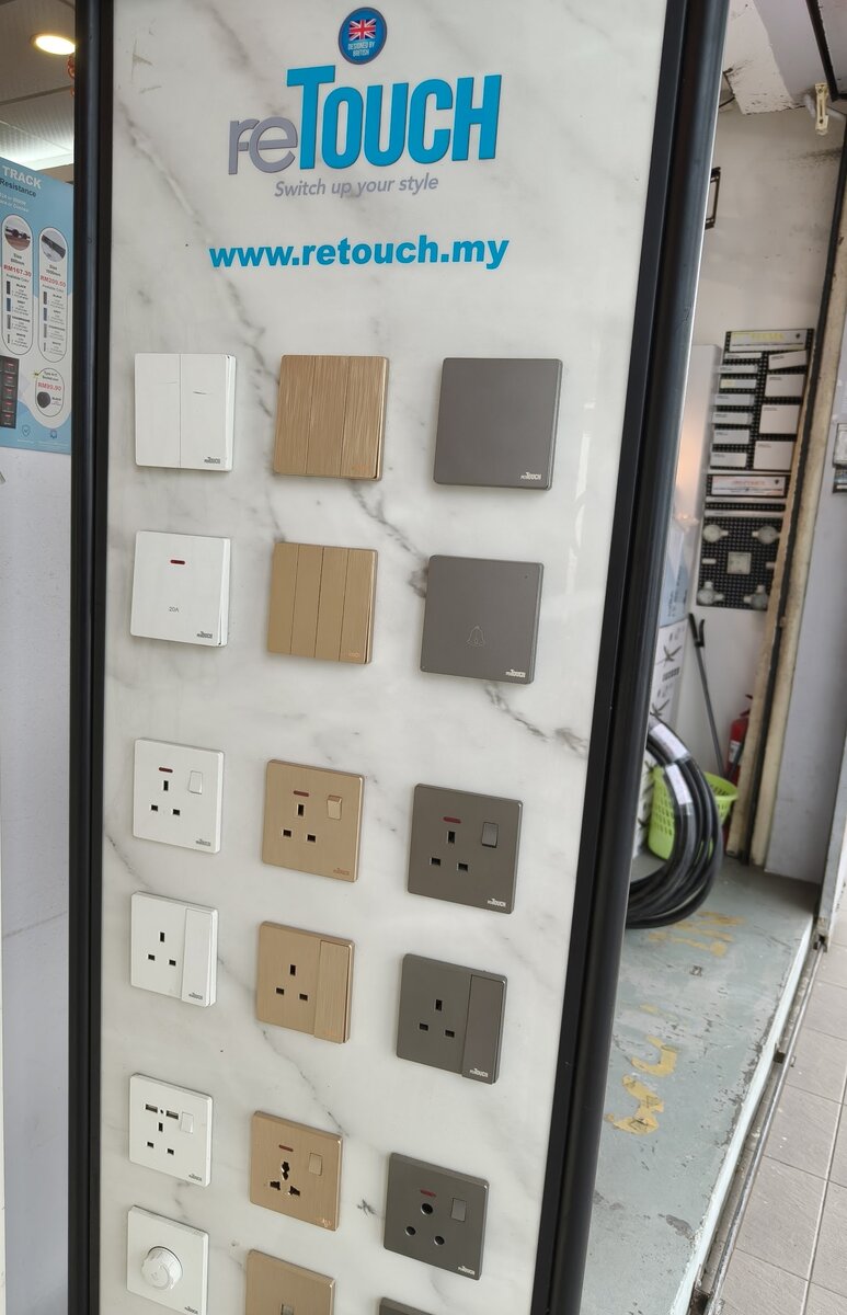 Marble-pattern display board with white, wood-grain and grey reTouch switches and sockets