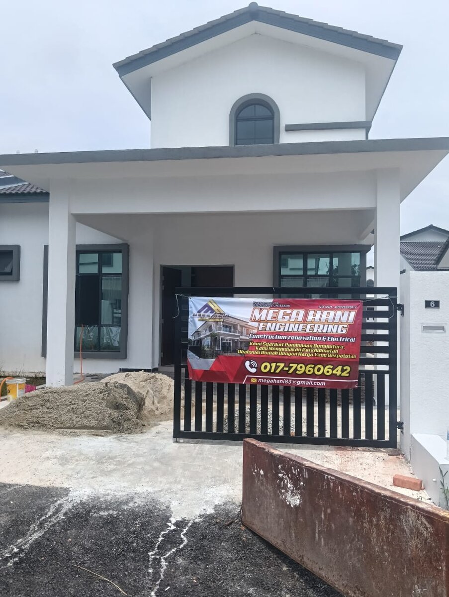 Newly built white house with a red Mega Hani Engineering banner on its gate showing the phone number 017-7960642