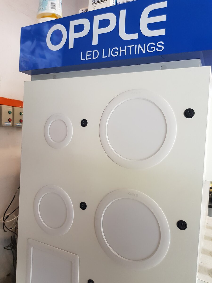 White display panel with round recessed LED downlights under a blue Opple LED Lightings header