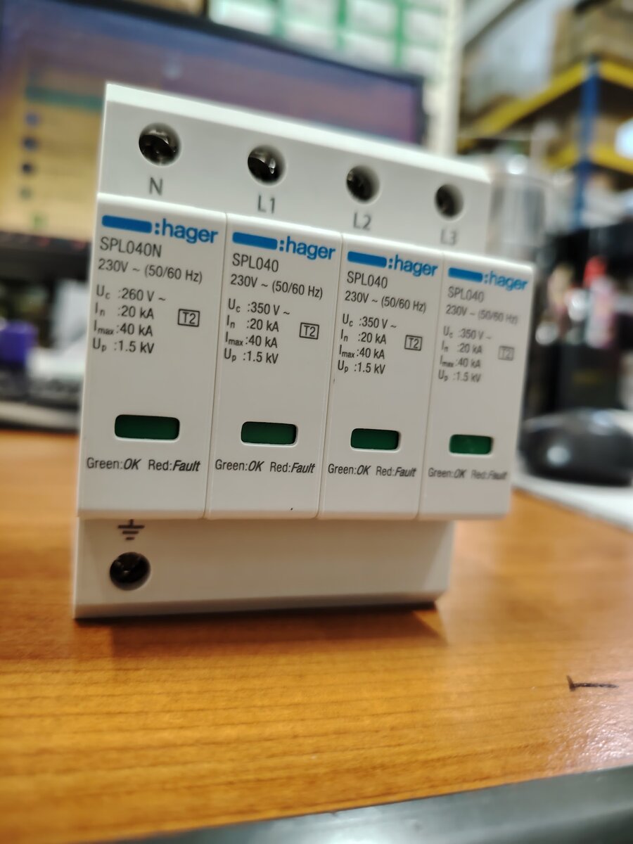 Four grey Hager plug-in surge protection modules labelled SPL040 and SPL040N on a base marked N, L1, L2, L3