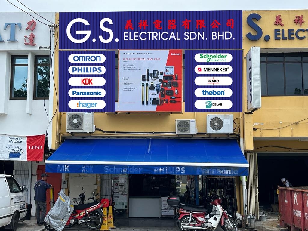 Two-storey shophouse with a blue G.S. Electrical Sdn. Bhd. signboard, white brand logo panels and a red and white Autonics banner above a blue awning