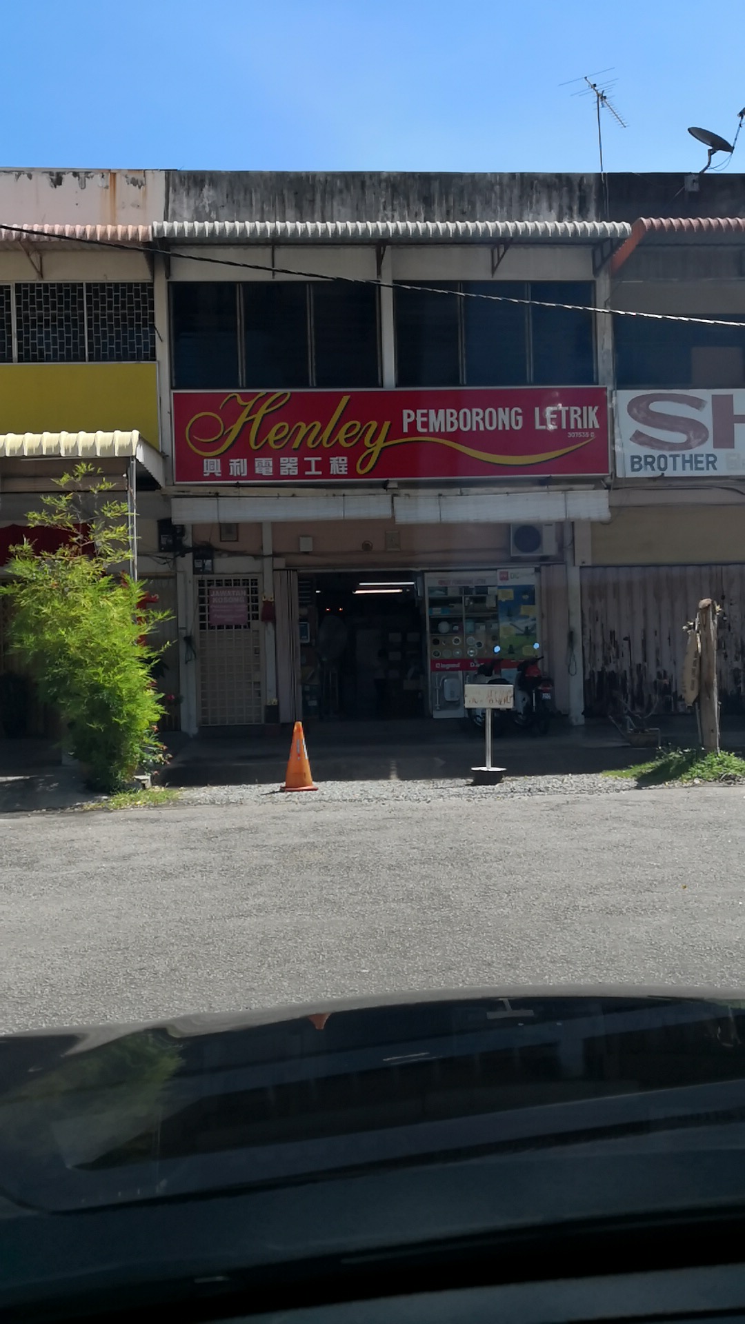 Two-storey shophouse with a red signboard reading Henley Pemborong Letrik and Chinese characters