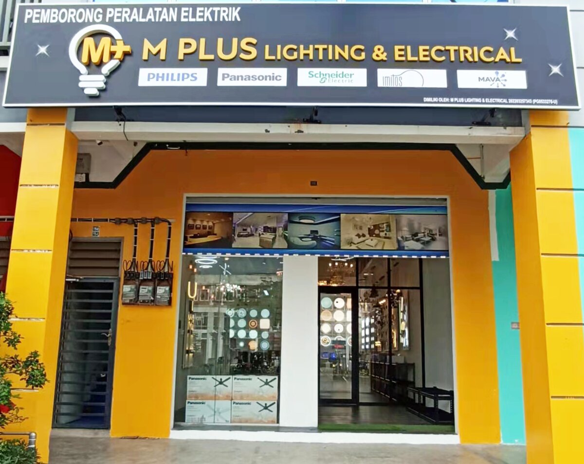 Yellow shopfront with a dark M Plus Lighting & Electrical signboard carrying five brand panels