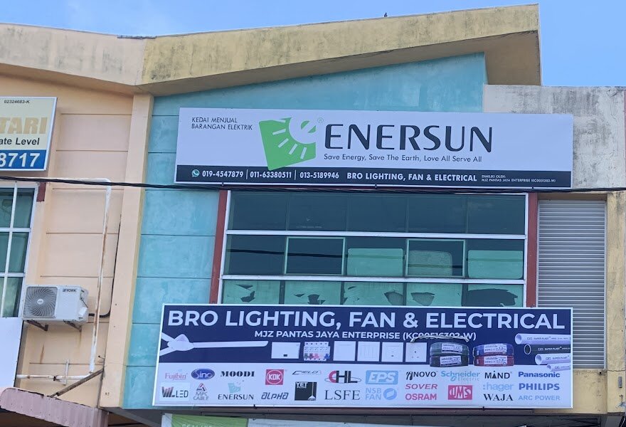 Upper-floor Enersun sign and a blue Bro Lighting signboard with switch, breaker, cable and conduit pictures and a grid of brand logos