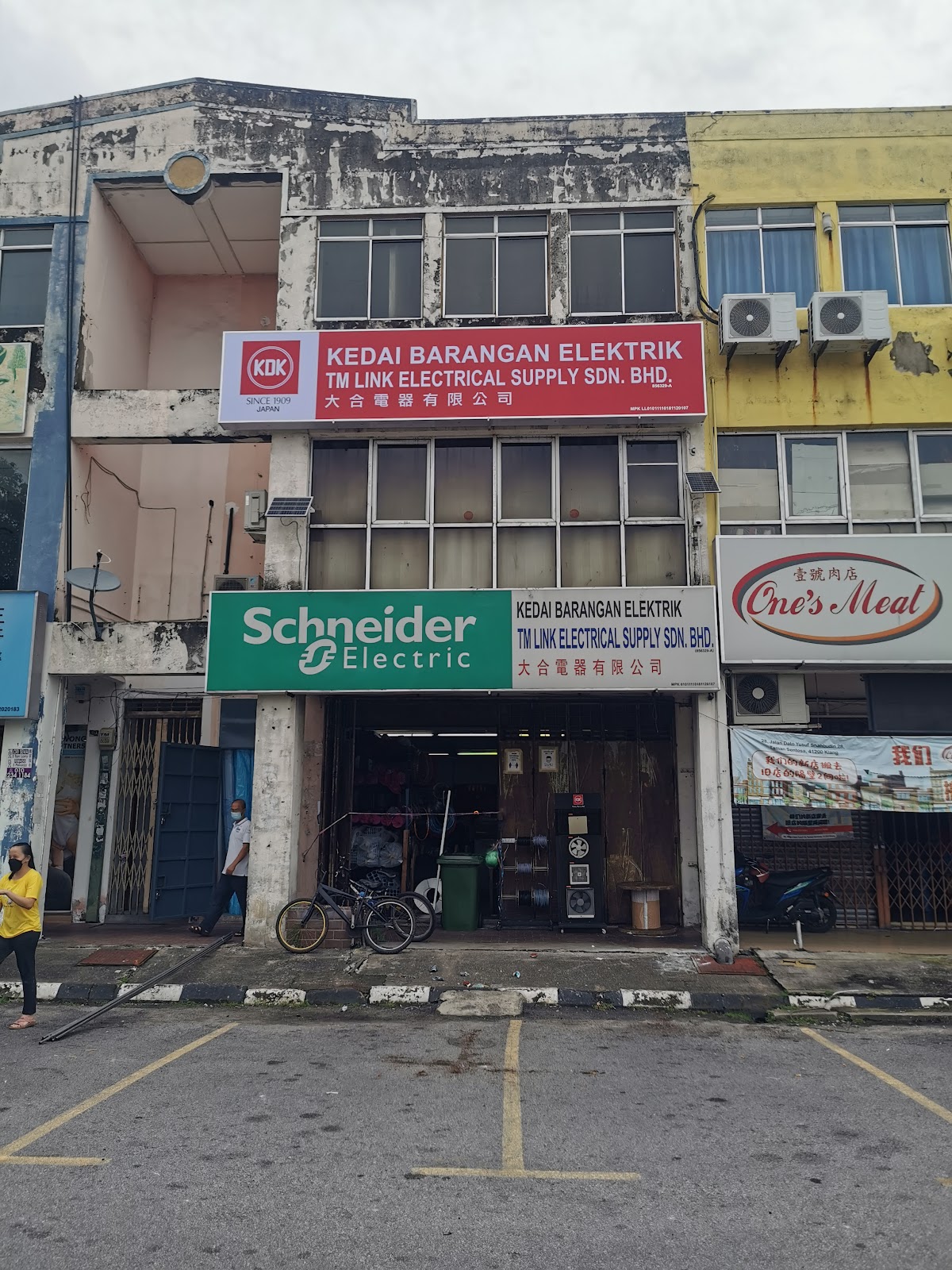 Shophouse with a red KDK and TM Link signboard on the first floor and a Schneider Electric signboard above the shop entrance