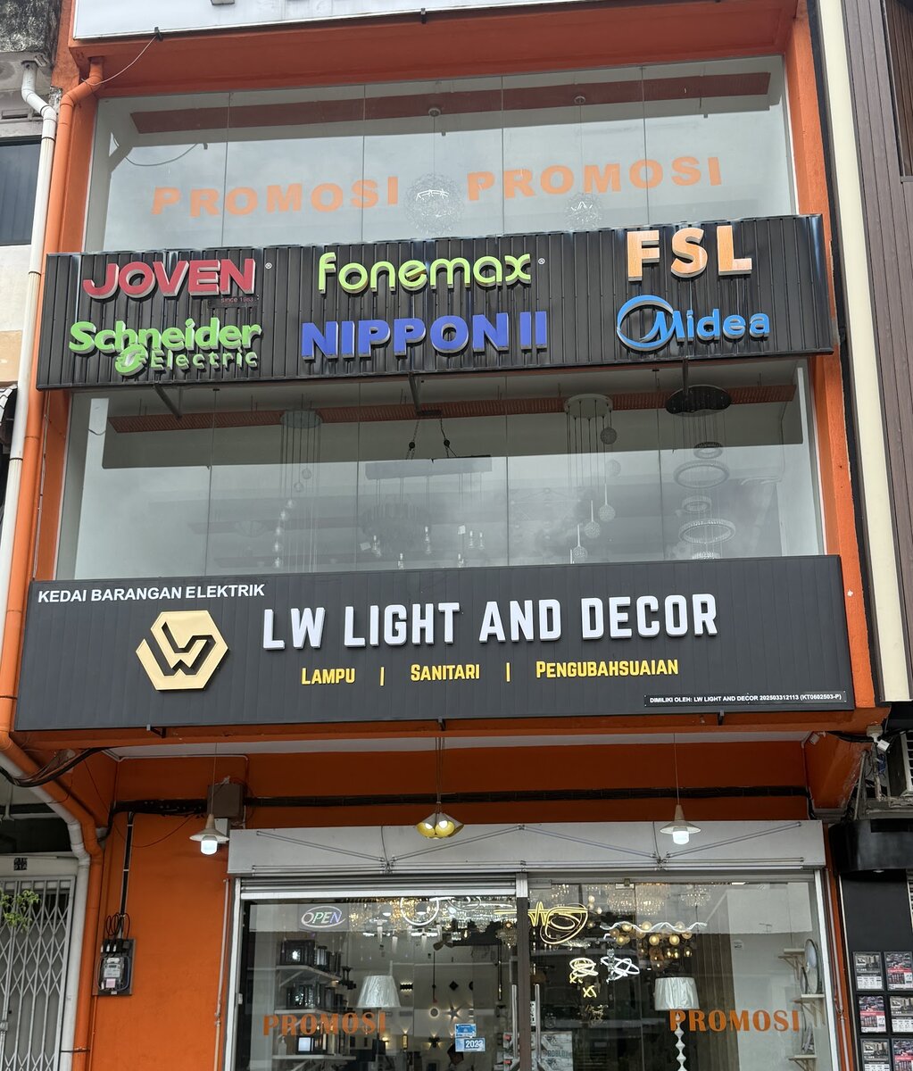 Orange and black shopfront with an LW Light and Decor sign, a row of brand logos above and lamps in the window