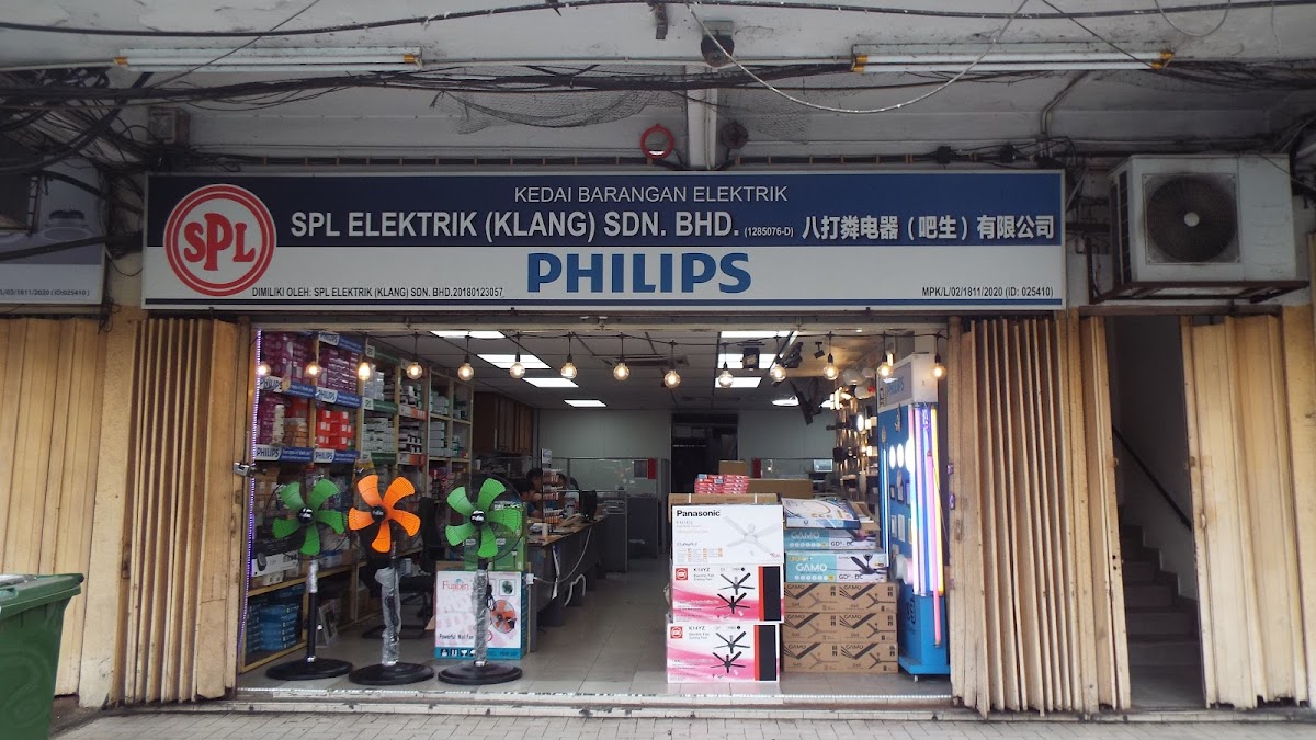 Shopfront signboard reading 'Kedai Barangan Elektrik, SPL Elektrik (Klang) Sdn. Bhd.' with a Philips logo, above an open shop with stand fans