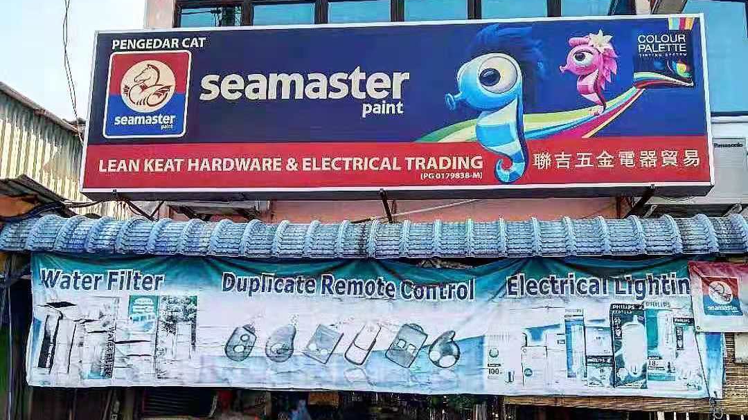 Shop signboard with the Seamaster paint logo and a seahorse mascot above a blue banner picturing water filters, remote controls and lamps