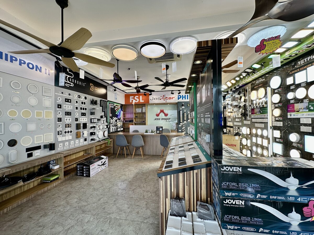 Shop interior with walls of LED ceiling lights and downlights, ceiling fans overhead and a service counter at the back