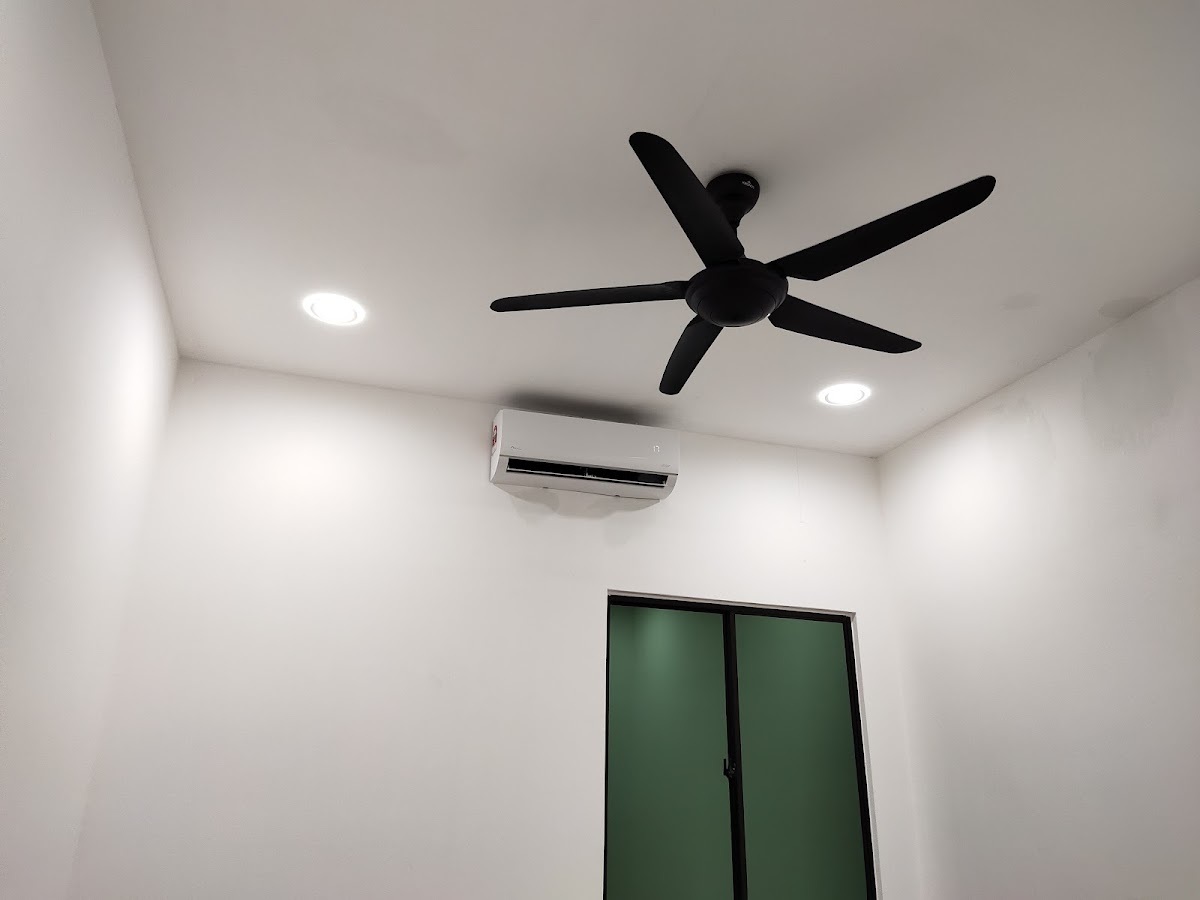 Small white room with a black five-blade ceiling fan, two recessed downlights and a split air conditioner above a green door