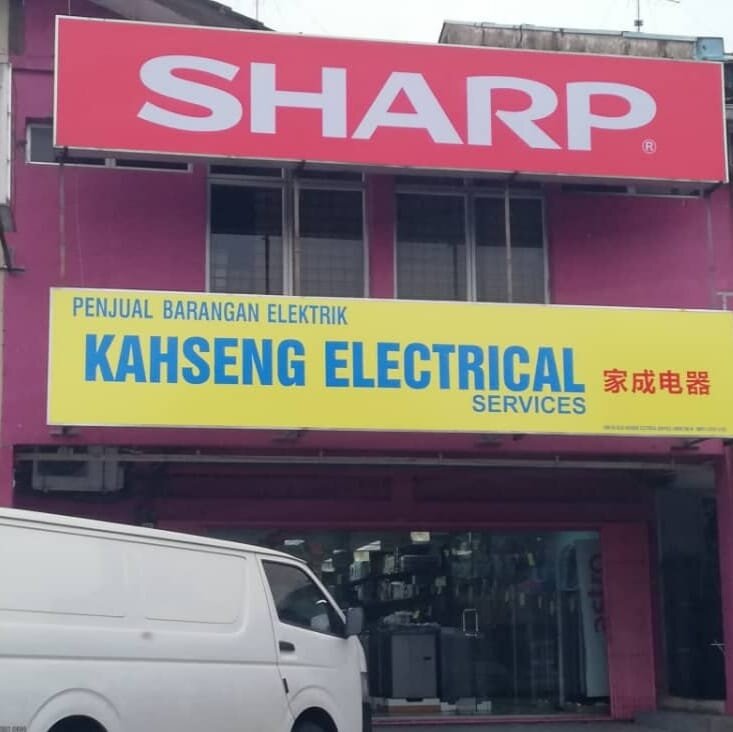 Shophouse with a red Sharp signboard above a yellow Kahseng Electrical Services signboard