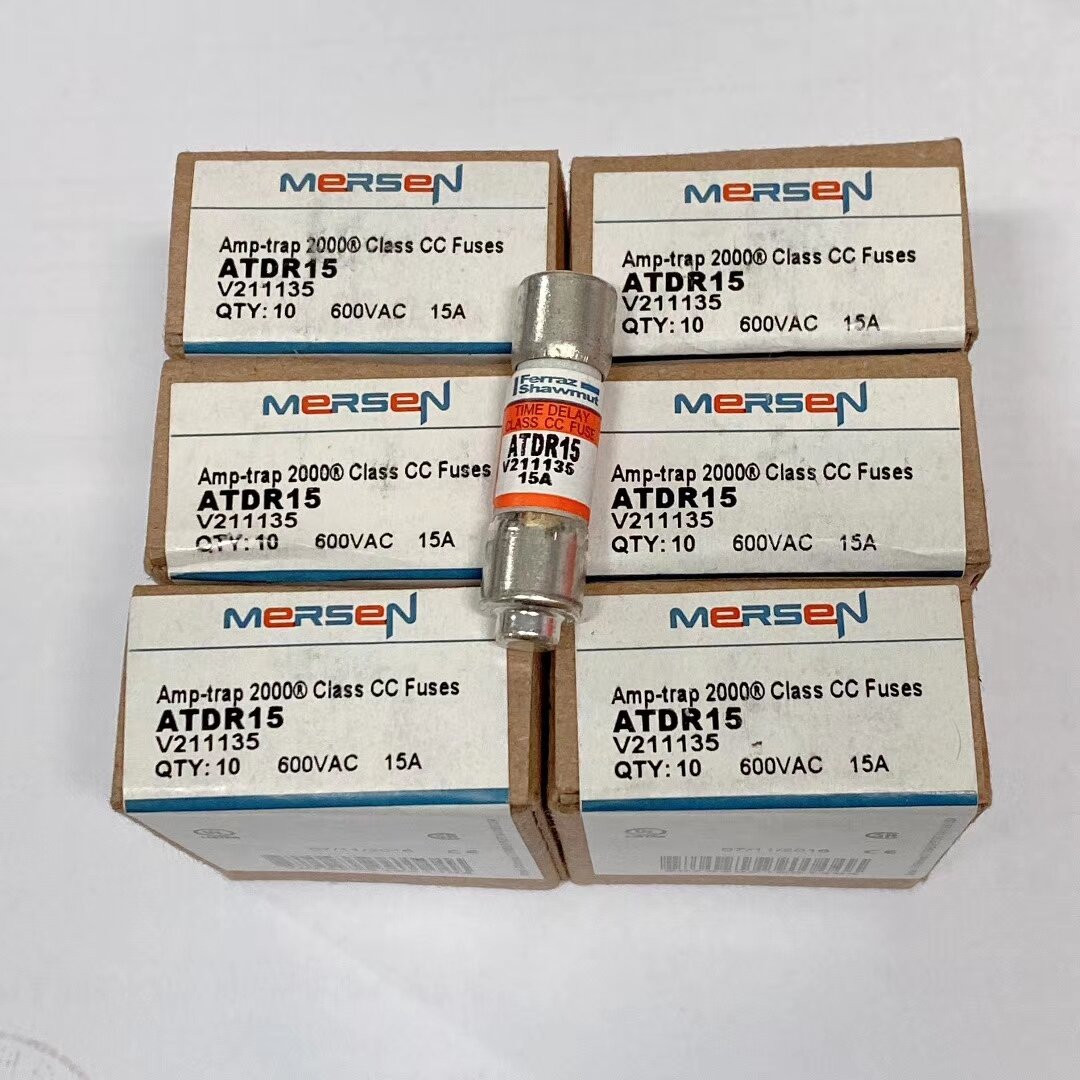 Six small boxes labelled Mersen Amp-trap 2000 Class CC Fuses ATDR15 with one cartridge fuse standing on them