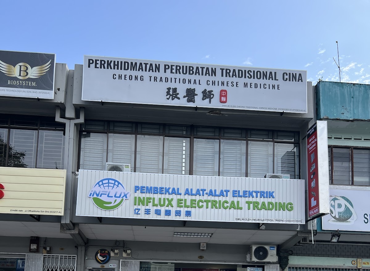 Two-storey shoplot with a white Influx Electrical Trading signboard on the ground floor and a Chinese medicine clinic sign above