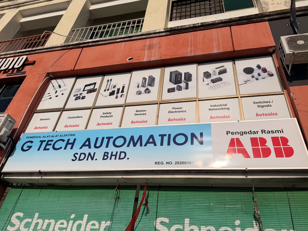 Shop signboard reading G Tech Automation Sdn Bhd and Pengedar Rasmi ABB, with Autonics panels above and green Schneider awnings below
