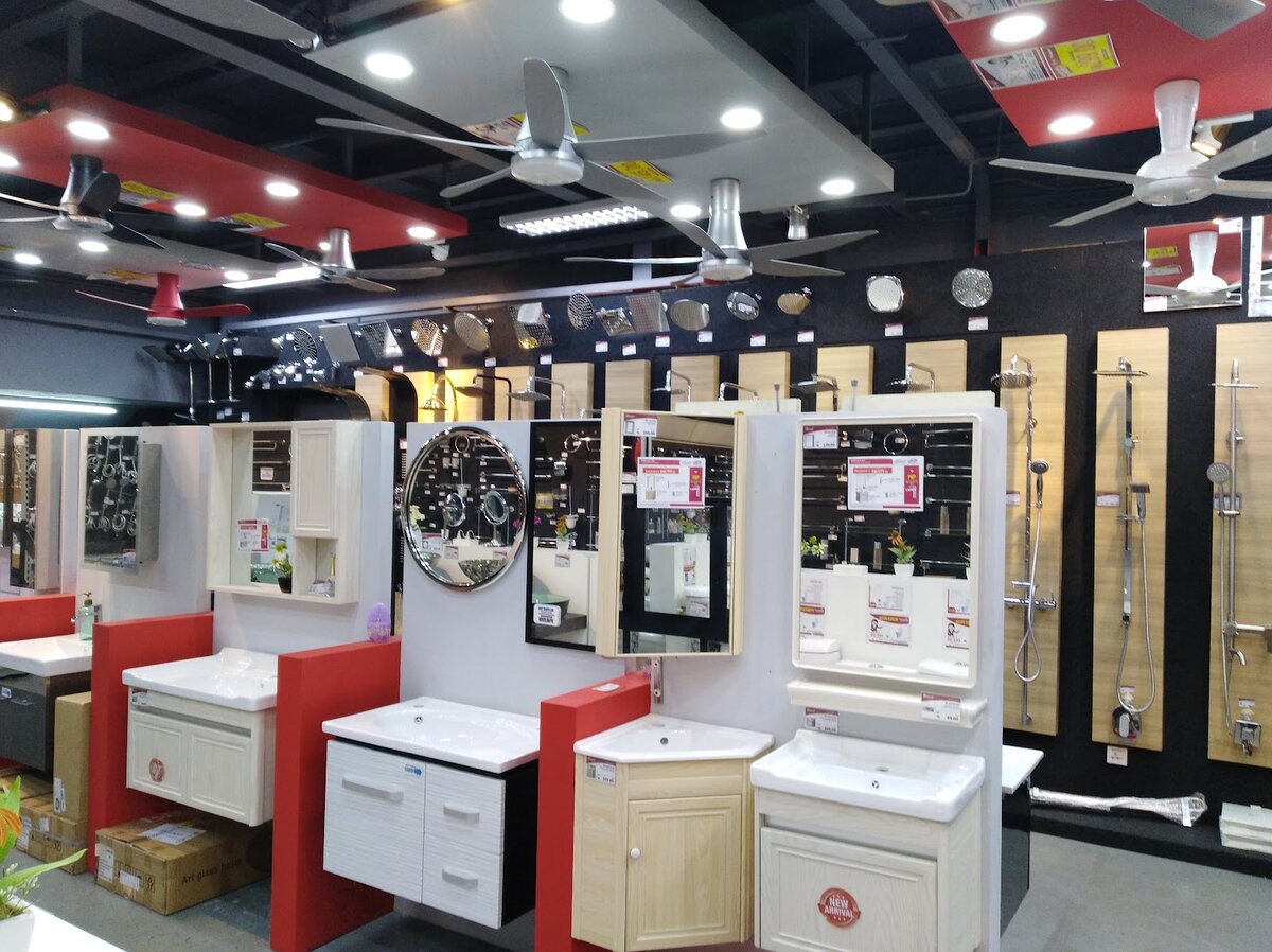 Showroom with priced ceiling fans hanging from the ceiling above vanity cabinets, mirrors and shower sets