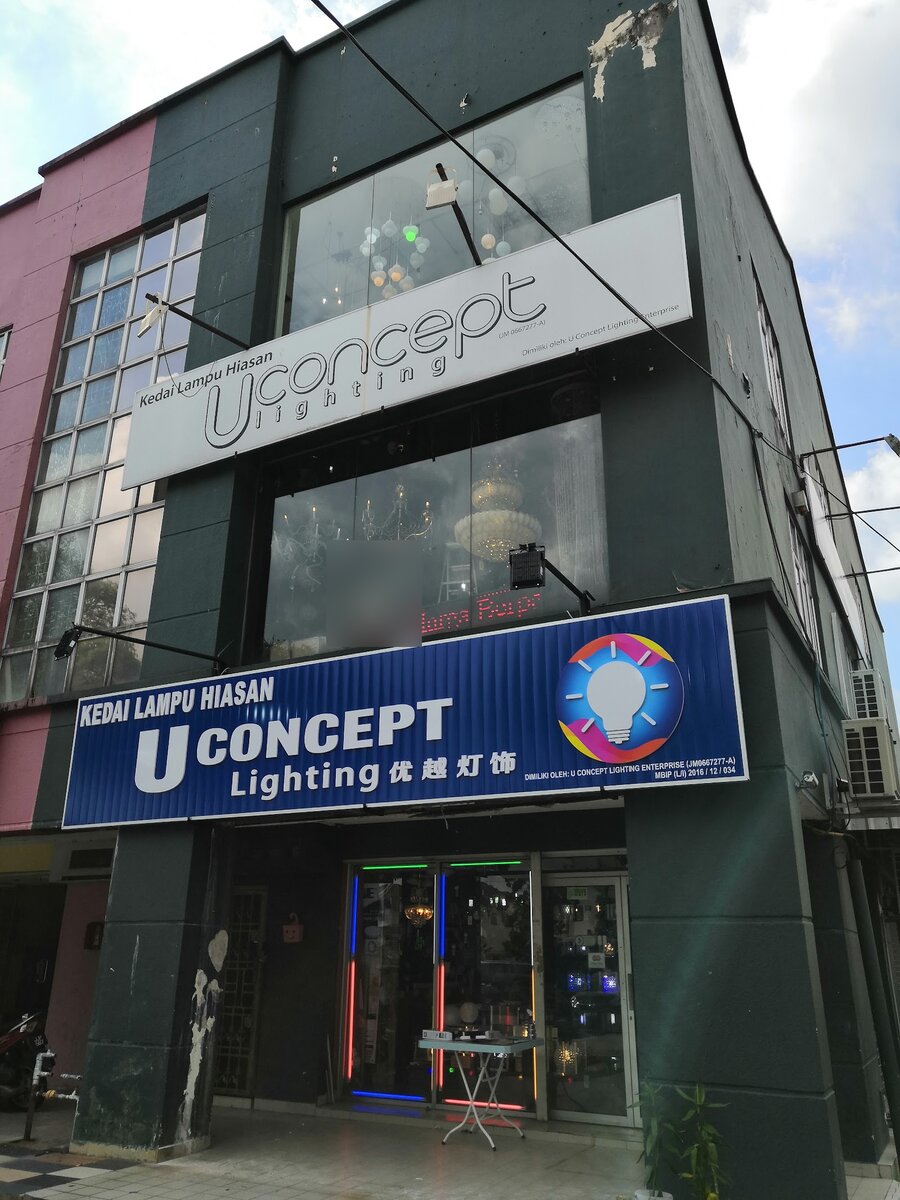 Two-storey shophouse with a blue "Kedai Lampu Hiasan U Concept Lighting" signboard and chandeliers behind the upper windows