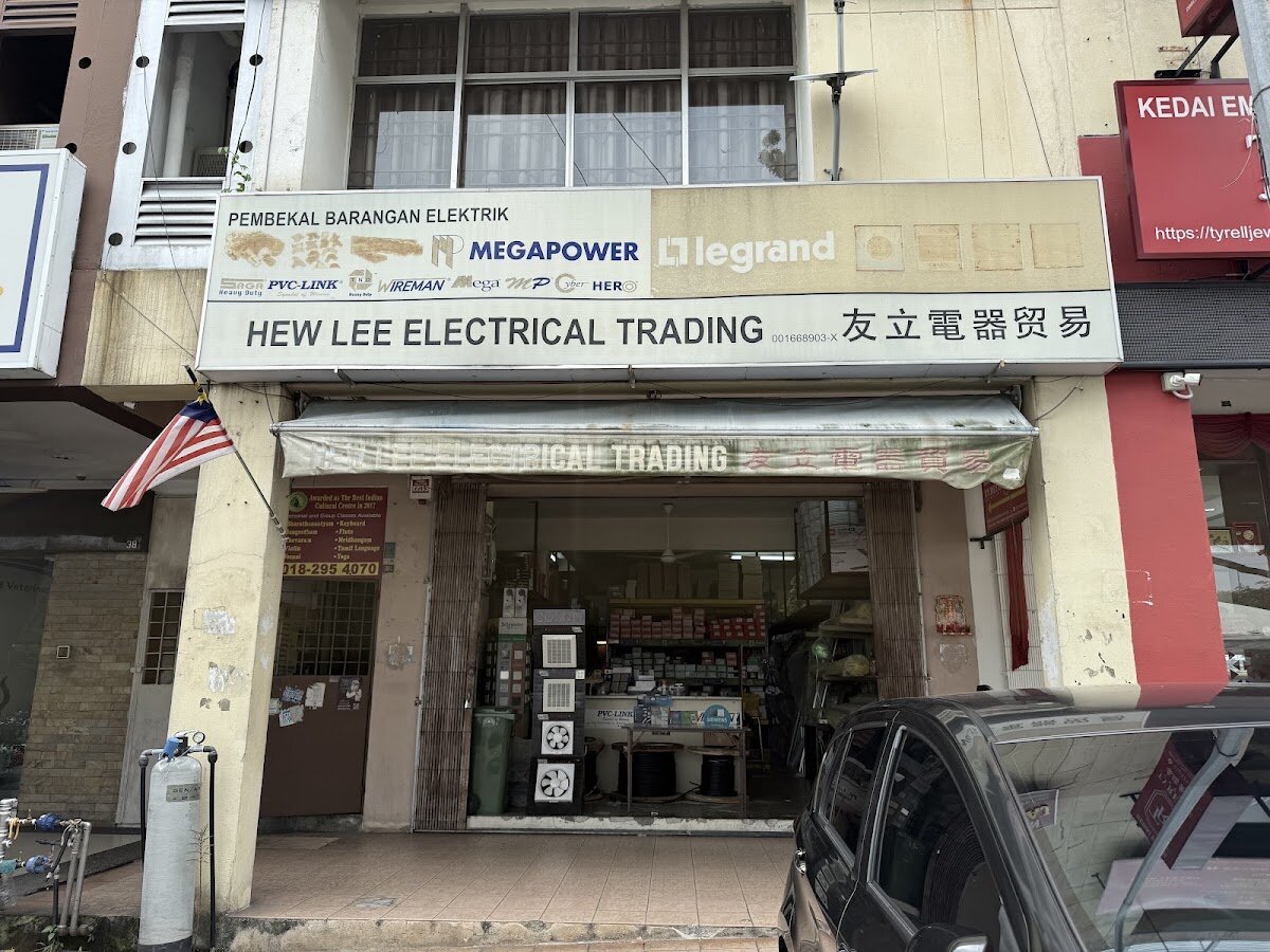 Shophouse front with the Hew Lee Electrical Trading signboard, brand logos and ventilating fans displayed at the entrance