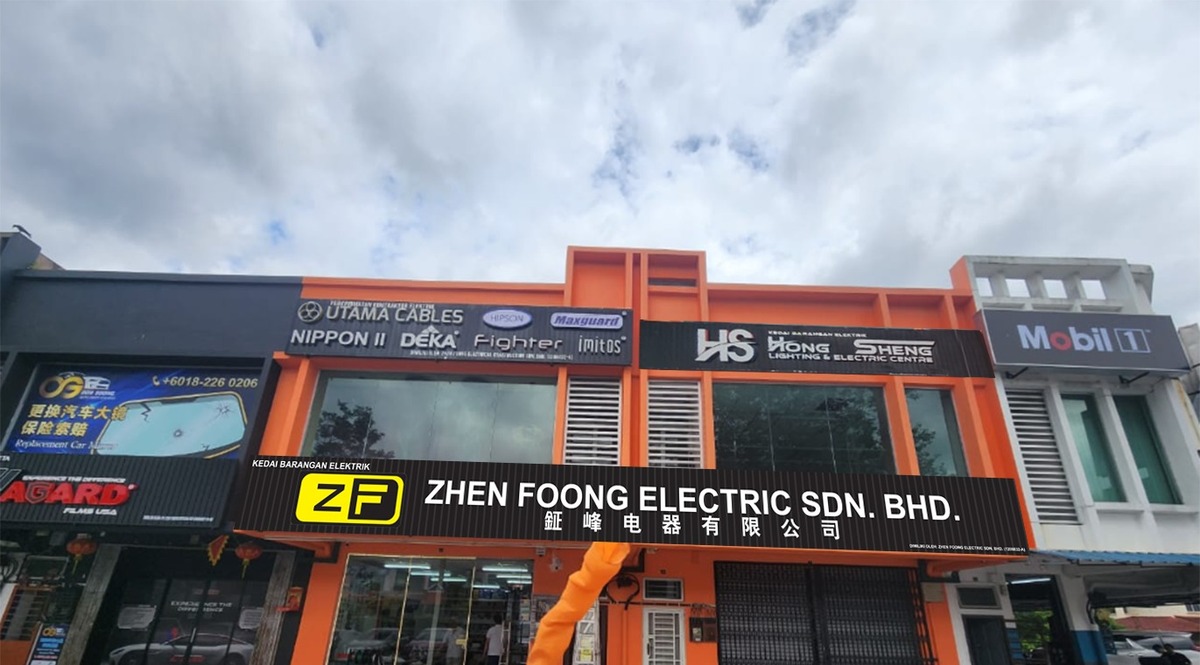Orange two-storey shophouse with a black signboard reading Zhen Foong Electric Sdn. Bhd. in English and Chinese, and upper signs for Utama Cables, Maxguard and Hong Sheng Lighting & Electric Centre