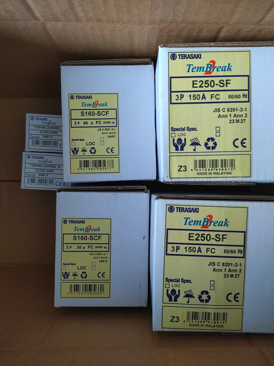 Boxes with yellow Terasaki TemBreak labels reading S160-SCF and E250-SF stacked in a cardboard carton