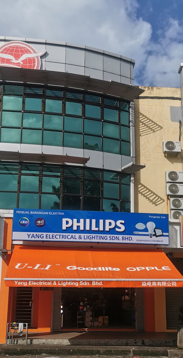 Shop building with a blue Philips signboard reading Yang Electrical & Lighting Sdn. Bhd. and an orange awning with U-Li, Goodlite and Opple logos over the entrance