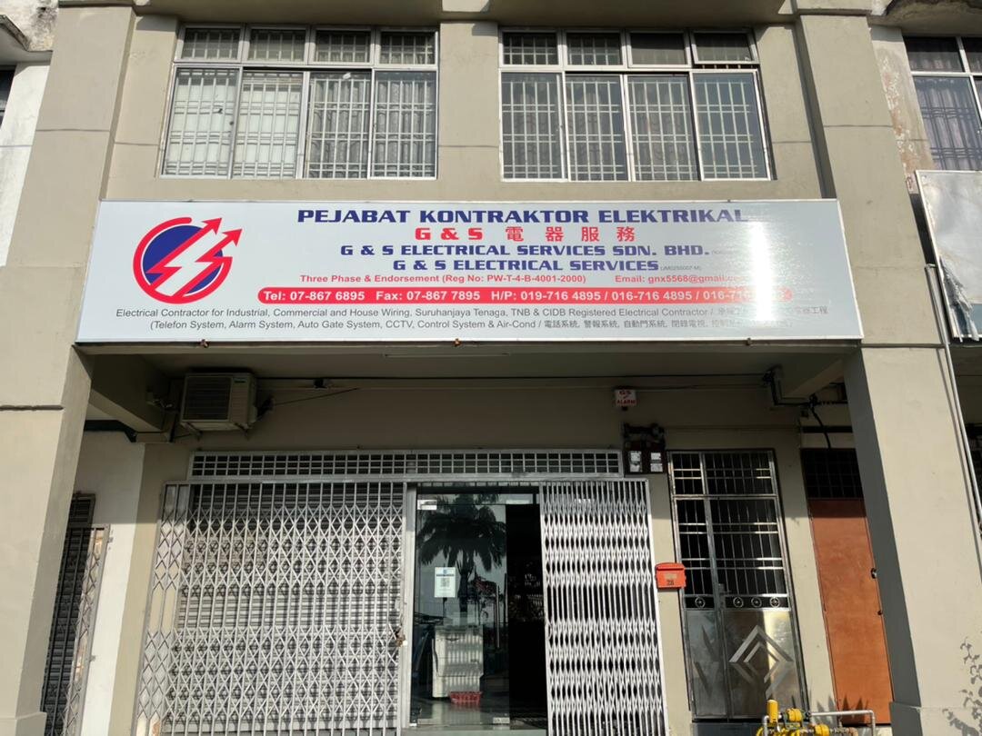 Two-storey shophouse with a white signboard reading Pejabat Kontraktor Elektrikal, G & S Electrical Services Sdn Bhd, above a grille door