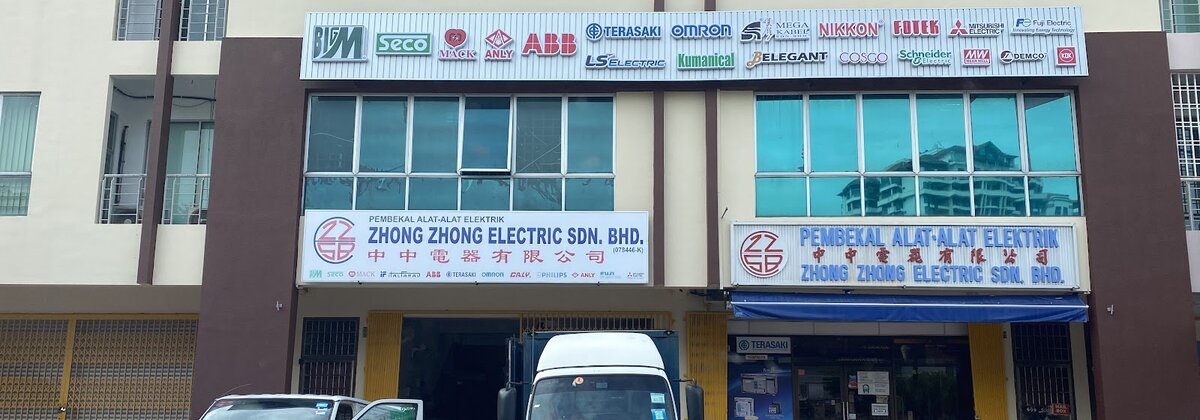 Shop row with a brand-logo fascia including ABB, Omron, Terasaki, Schneider Electric and Mega Kabel above Zhong Zhong Electric signboards