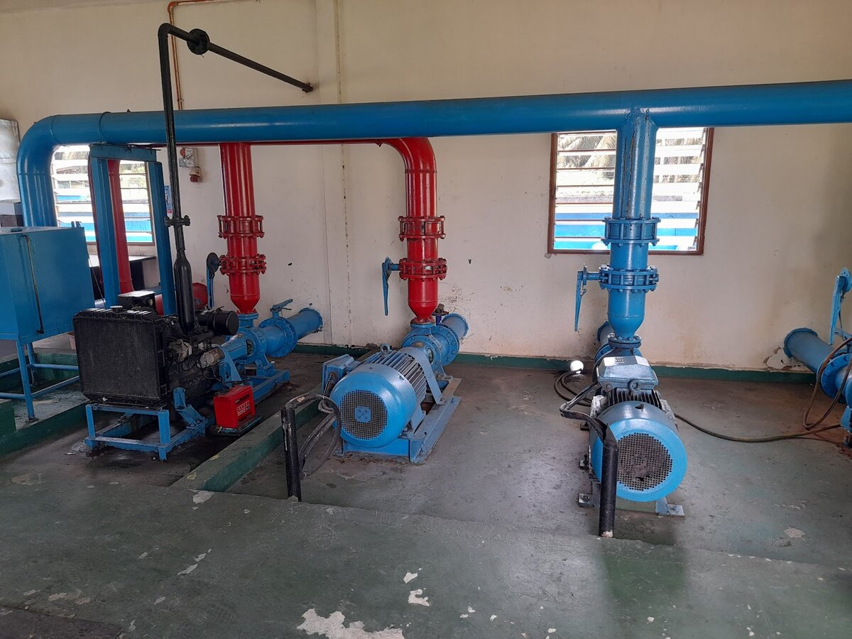 Pump room with blue electric pumps, a diesel engine set and red and blue pipework