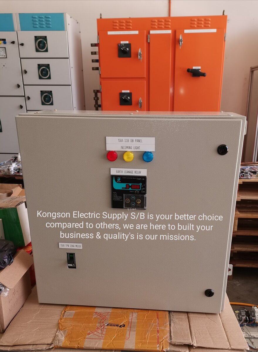 Grey wall-mounted electrical panel with red, yellow and blue indicator lights and an earth leakage relay, in front of orange and white panels
