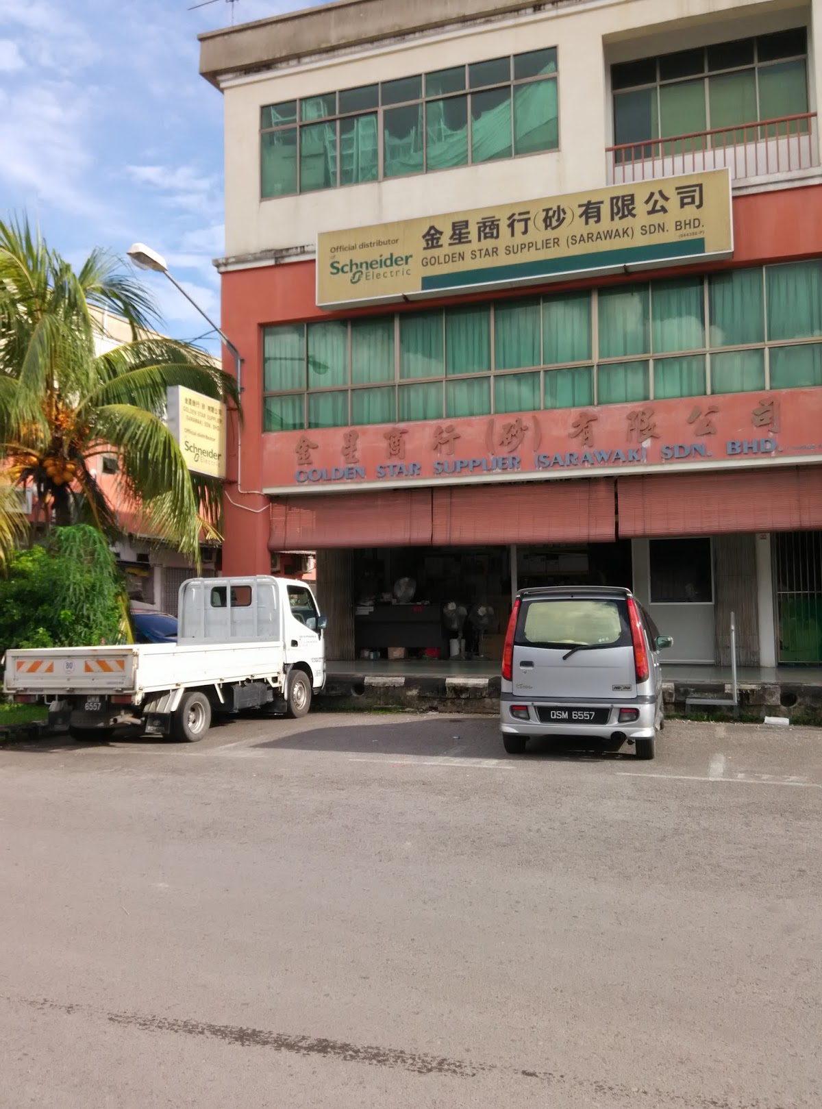 Three-storey shophouse with a Schneider Electric official distributor sign and a red Golden Star Supplier signboard in Chinese and English